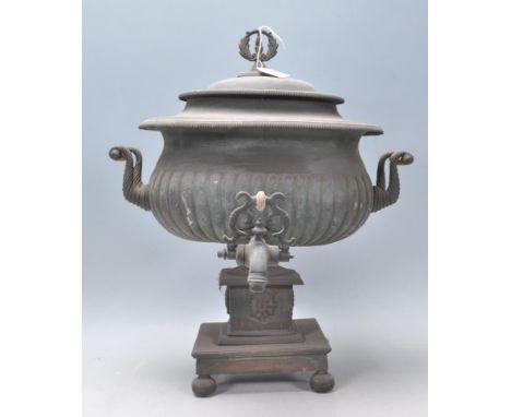 A 19th Century Victorian samovar having a reeded body with twin turned bone handles, raised on a square plinth base on bun fe