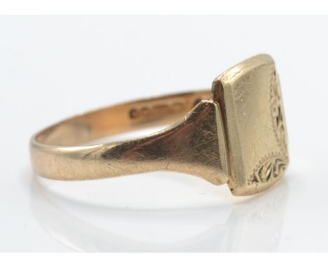 A 9ct gold signet ring. The plain cartouche&nbsp; with chased edges to tapering shoulders and plain shank. Hallmarked Birming
