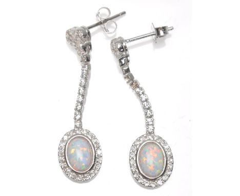 A pair of ladies silver drop earrings set with oval opal panels and CZ's. Weight 4g. Measures 3.5cm.