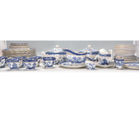 A large Booths 'Real Old Willow' service being transfer printed with blue and white decoration with gilt detailing to include
