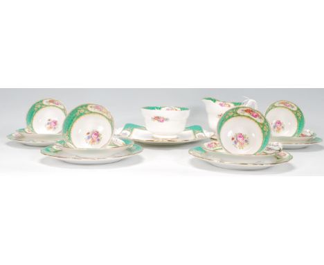 An early 20th Century part Paragon tea service having white and green ground with floral painted borders and centres. The set