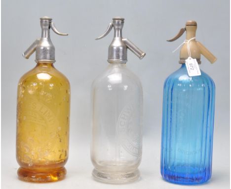 A group of three 1930's vintage advertising soda siphon's to include a blue glass Hooper &amp; Struve siphon, an amber glass 