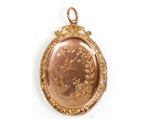 A vintage 9ct yellow gold back and front locket pendant of oval form having engraved swallow decoration and engraved borders.