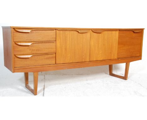 A 1960's retro vintage teak wood sideboard in the manner of McIntosh having the central twin door cupboard with shelves&nbsp;