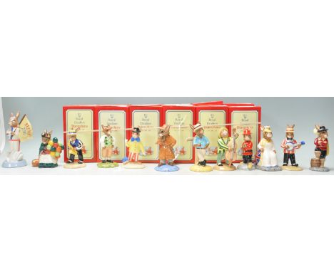 A group of twelve Royal Doulton Bunnykins ceramic figurines to include England Athlete Bunnykins Sydney 2000 (no. 1585), Old 