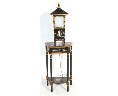 A 20th Century Chinese lacquered side table cartouche shaped top with a single drawer, raised on turned supports with a lower