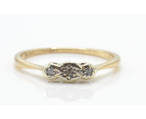 A 9ct gold platinum and diamond 3 stone ring. The ring set with 3 illusion set diamonds in platinum with basket mounts on pla