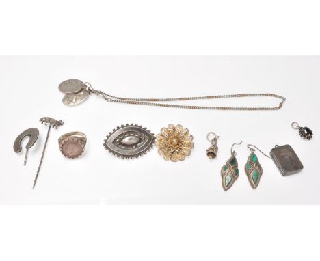 A collection of antique silver jewellery to include a Victorian horseshoe stickpin, a Victorian mourning brooch, a pair of dr