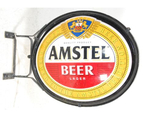A good advertising Amstel Beer / Lager light box of oval form mounted to an iron bracket.&nbsp;H105cm W70cm