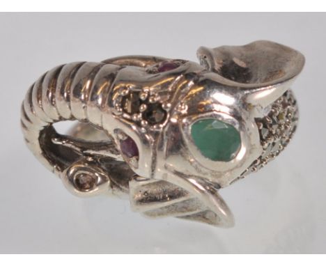 A stamped 925 silver ring in the form of  an elephant set with red and green stones, and marcasites. Stamped 925. Weight 11.8