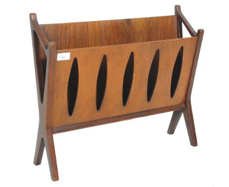 A retro mid century walnut magazine rack&nbsp; stand. The x-frame supports with returns supporting a pierced leaf motif desig