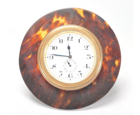 A 19th century tortoiseshell, silver and brass goliath easel clock. The circular tortoiseshell frame surrounding a brass case