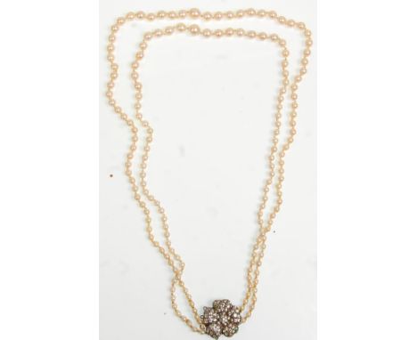 An lovely vintage 20th Century pearl necklace having two rows of graduating pearls on a silver hallmarked clasp set with colo