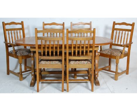 A 20th Century vintage retro Ercol style large extending country kitchen dining table together with a set of similar dining c