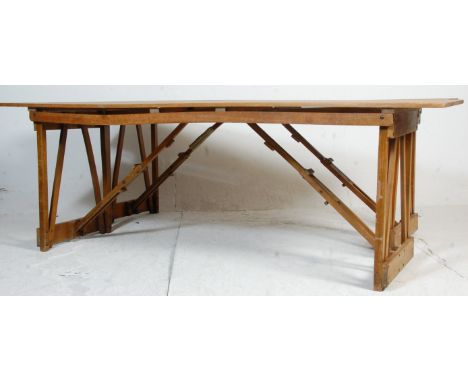 A pair of two mid 20th century vintage retro industrial folding trestle tables - refectory dining tables having wooden block 