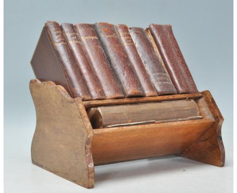 An early 20th Century oak Asprey's&nbsp; of London small book shelf / book stand complete with a selection of leather bound a