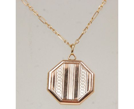 A hallmarked 9ct yellow gold locket pendant of octagonal form having engine turned decoration. Hallmarked for London date let