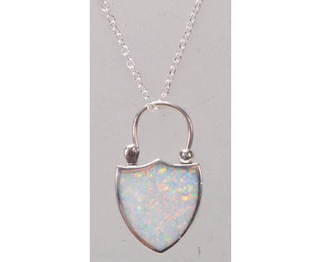 A stamped 925 silver pendant necklace having a shield design lock pendant set with an opal panel. Weight 6g. Chain measures 1