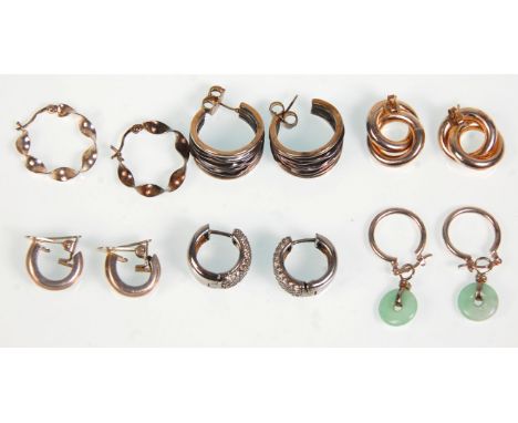 A group of six pairs of silver earrings to include a pair of crinkled hoop examples, a pair set with white stones, a pair wit