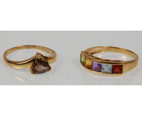 Two hallmarked 9ct yellow gold ladies rings. One set with five multi coloured stones to a pierced mount. Hallmarked for Sheff