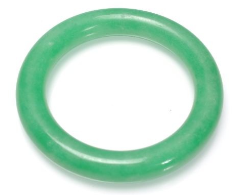 A Chinese Jade slave bangle of typical round form.&nbsp;