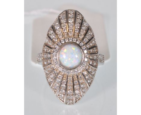 A stamped 925 silver Art Deco ring having a navette shaped panel set with white stones and a round opal. Weight 8g. Size R.