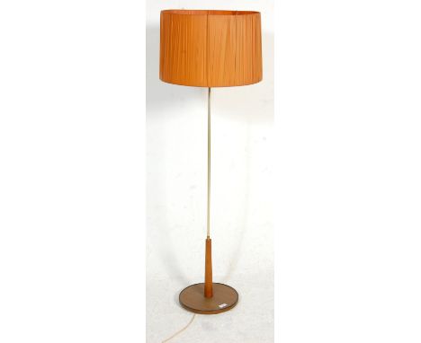 A vintage retro 1970's standard lamp having a round dark wood base with a chromed column with an orange cylindrical lamp shad