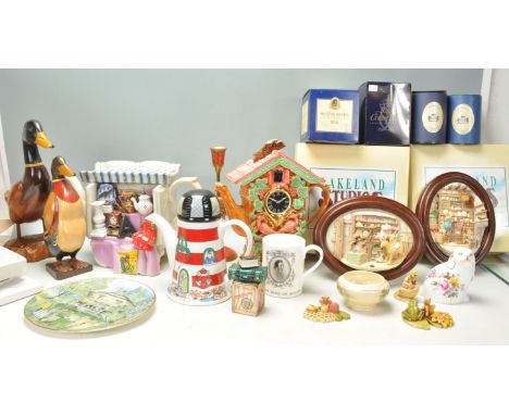 A large mixed group of mostly ceramic wares / ornaments to include 2x wooden ducks, lighthouse teapot, shop plaques from Lake