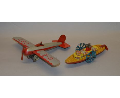 An unboxed vintage Mettoy tinplate Monoplane 'G-EOBT' in silver and red with fixed key, G/G+ overall although mechanism does 