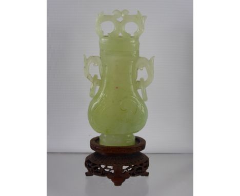 Chinese 20th Century Pale Celadon Vase and Cover, the pear shaped vase features white inclusions and stylized dragons carved 