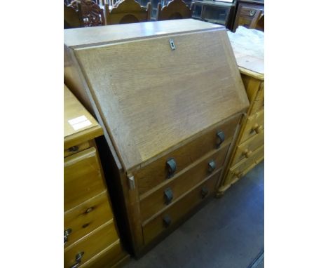 A Light Oak Mid 20th Century Drop Front Bureau, with three graduated drawers and fitted interior.