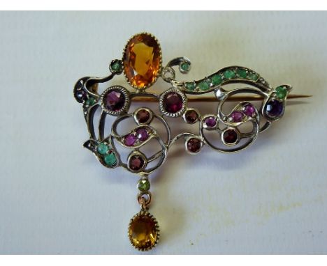 An Antique Silver and Gold, Ruby, Emerald, Garnet and Amethyst Brooch.