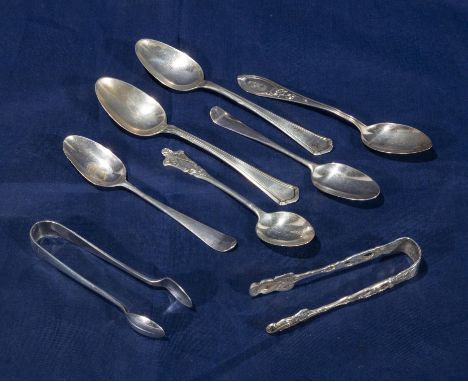 A selection of silver spoons and tongs and others