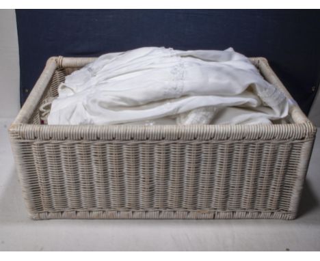 A basket containing children's vintage Christening gowns