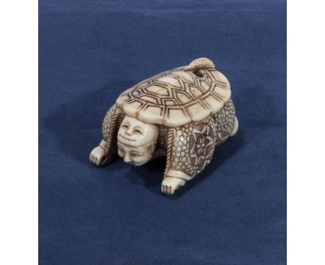 A signed ivory netsuke of an actor with a turtle shell