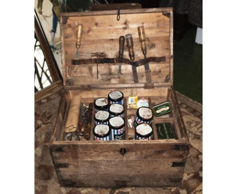 A pine box with various vintage tools