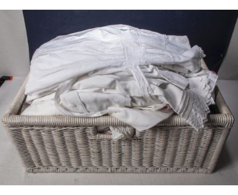 A basket containing children's vintage nightgowns and other items
