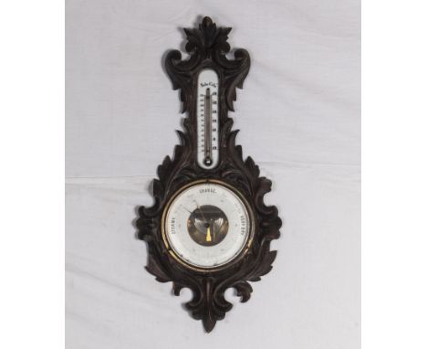A carved oak barometer