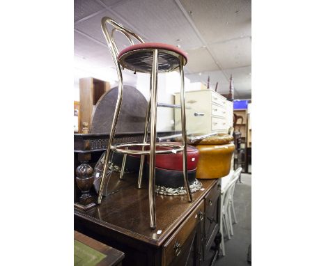 AN OVAL WALL MIRROR IN GILT FRAME, A TUBULAR METAL HIGH STOOL AND A POUFFE AND A TUBULAR AND GLASS WHAT-NOT AND A MIRROR 