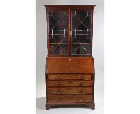 George III bureau bookcase, the astragal glazed top above a sloping fall enclosing four small drawers and a small door above 