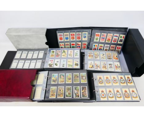 Five binders of cigarette cards, organised into sets to include Boxing Personalities, The Story Of Navigation, Treasure Trove