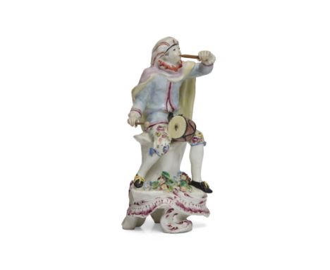 A Bow porcelain Commedia dell'arte figure of a drummer, c.1760, probably Mezzetin, modelled seated on a tree-stump, wearing a