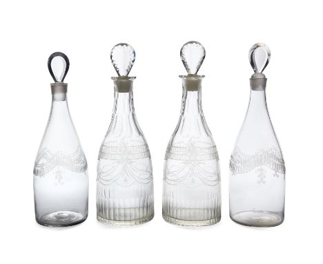 A pair of George III glass decanters and stoppers, early 19th century, with faceted neck and foot, etched swags and bands of 
