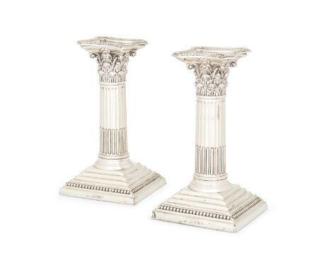 A pair of Victorian silver candlesticks, London, 1887, Edward Hutton, of short Corinthian columnar design with stepped square