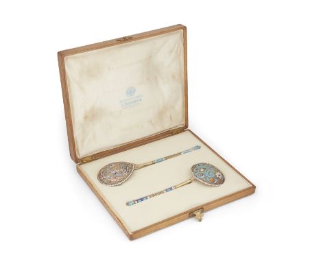 A pair of enamelled Russian silver gilt spoons retailed by A. Lyubavin, St Petersburg, each with maker's mark of Vasily Andre