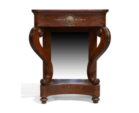 An Empire flame mahogany console table, c.1810, gilt metal mounted, with scrolling sabre supports and mirrored back, raised o