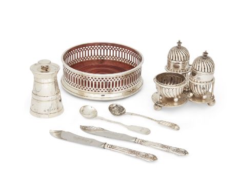 An Edwardian silver condiment set, London, 1903, Goldsmiths and Silversmiths Co., comprising two fluted peppers and a salt on