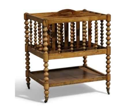 A Victorian rosewood Canterbury, c.1840, with four divisions, lower shelf, bobbin supports, raised on castors, 47cm high, 41c
