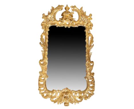 A George III Chippendale style giltwood mirror, c.1790, the crest carved with figure playing a lute within broken swan neck p