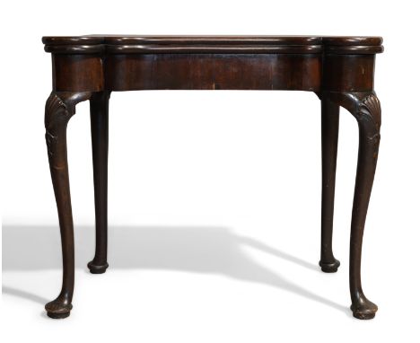 A George II mahogany concertina tea table, possibly Irish, c.1740, the top with turret corners, raised on cabriole legs caved